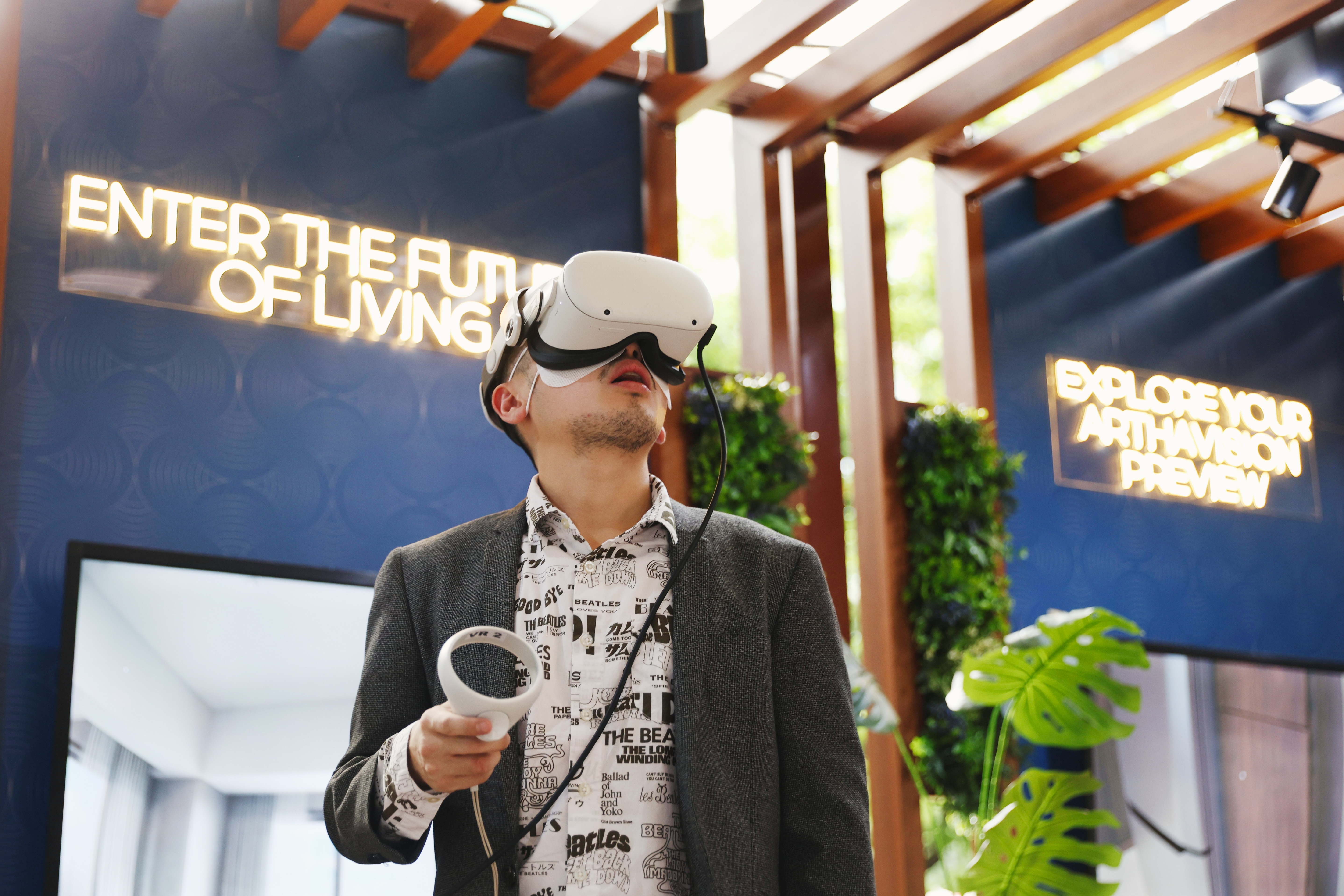 A man using VR goggles to tour Sondris virtually